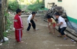 Children playing with marbles at Ban Houay Thong Village